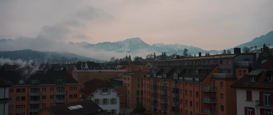Fog flows past mountains near alpine town