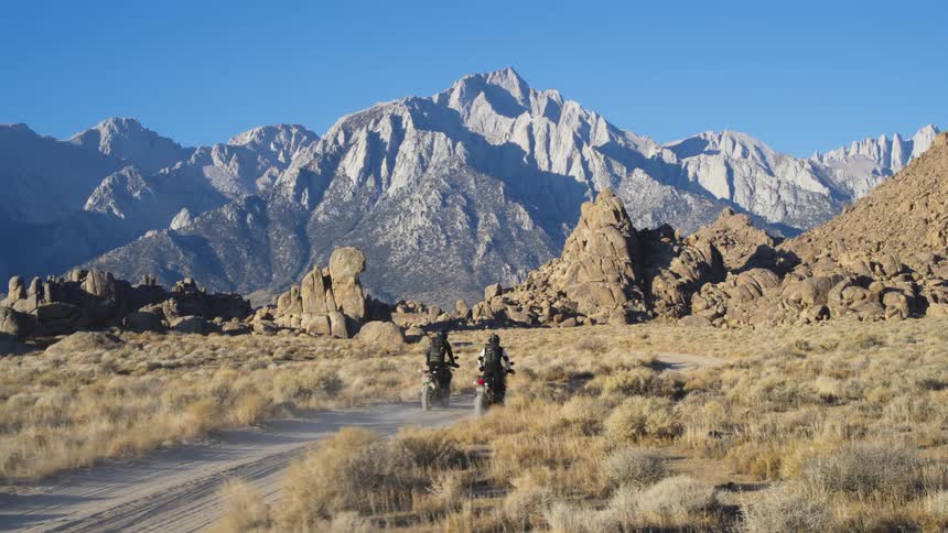 A view of two people riding dirt bikes