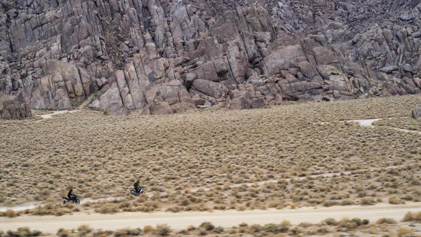 An aerial view of two people riding dirt bikes
