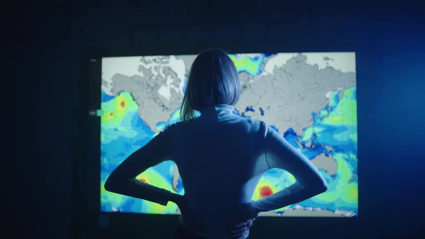 A woman is watching the monitor