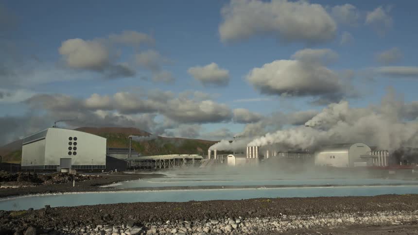 A time lapse of smoke pouring out of a factory