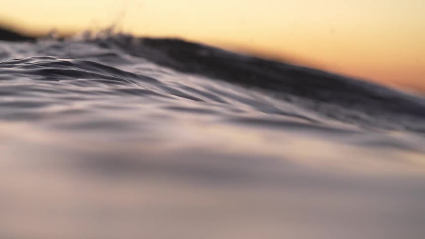 Sea waves are moving in the ocean at dusk