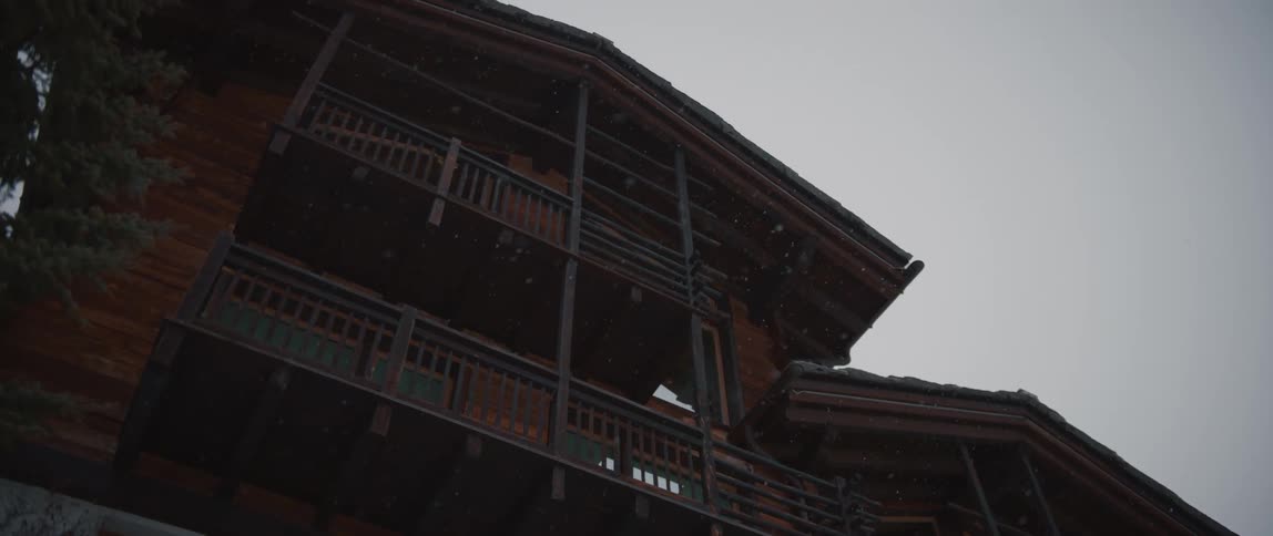 A view of a building is displayed while its snowing