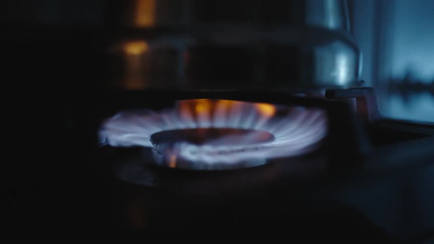 Gas stove with burning blue flames