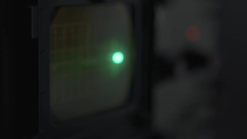 A flashing green light moving across a screen on a machine