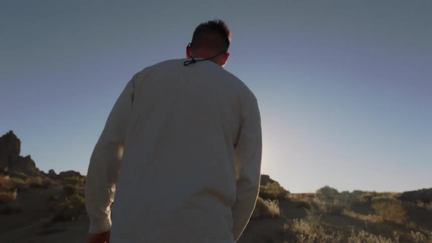 A man is hiking up the hill