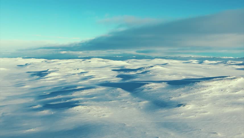 Aerial view of snowy field with ice dunes