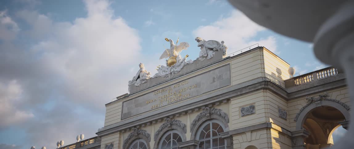 Statues on top of gloriette in vienna under a blue sky