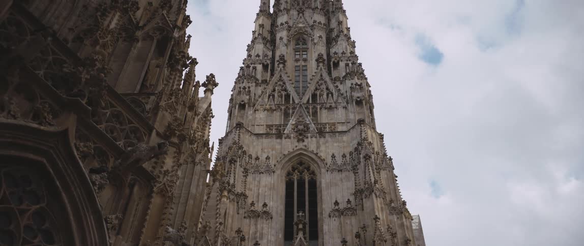 Large cathedral with intricate ornate designs under a cloudy blue sky