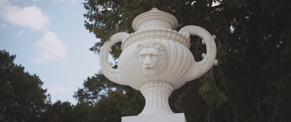A sculpture of a vase outdoors during the day
