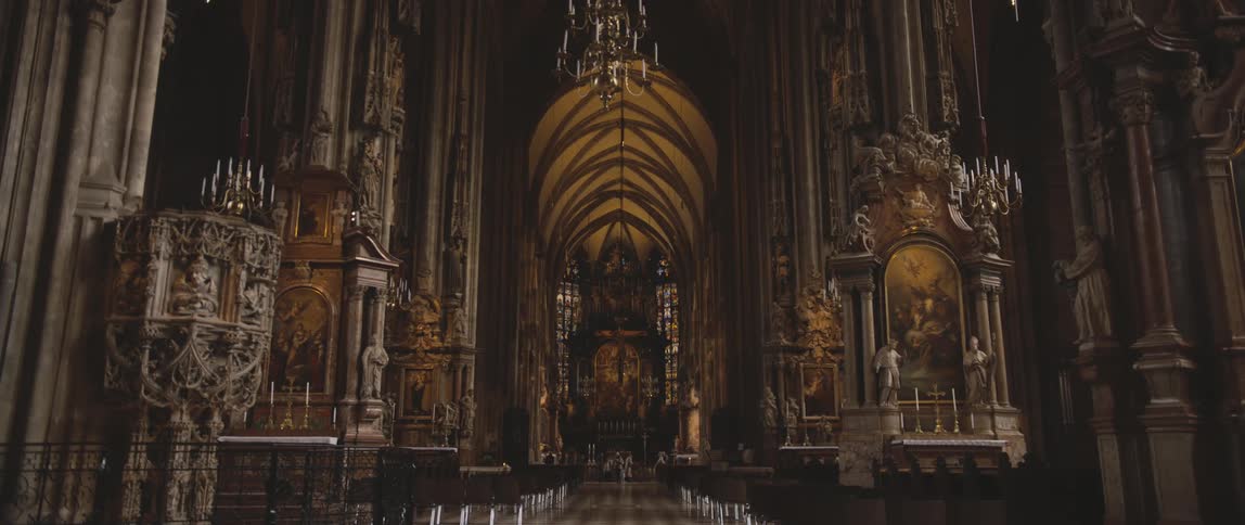 Detailed sculptures and balconies line the walls of an ornate church