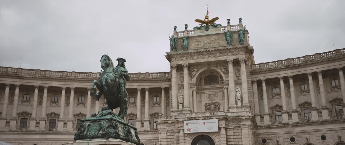 The statue of prince eugene of savoy in front of the hofburg palace in vienna under a cloudy sky