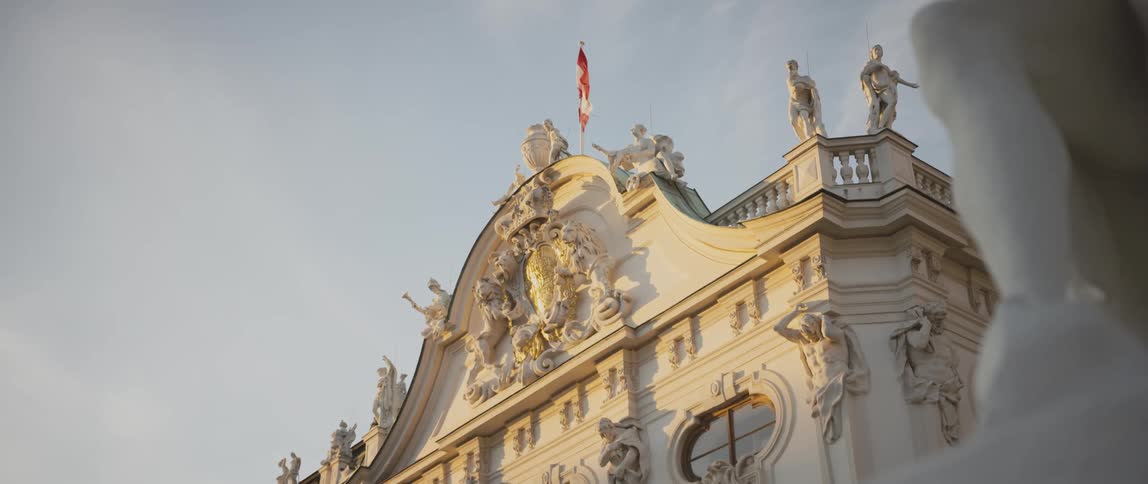 Statues and a flying flag on the roof of a cement monument