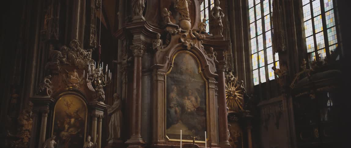 Elaborately carved columns in a cathedral during the day