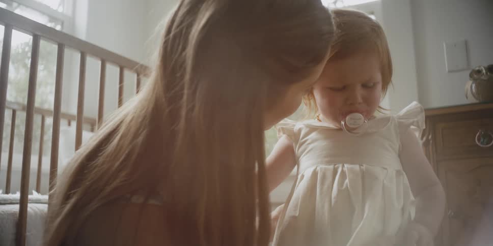 A woman comforts a crying infant