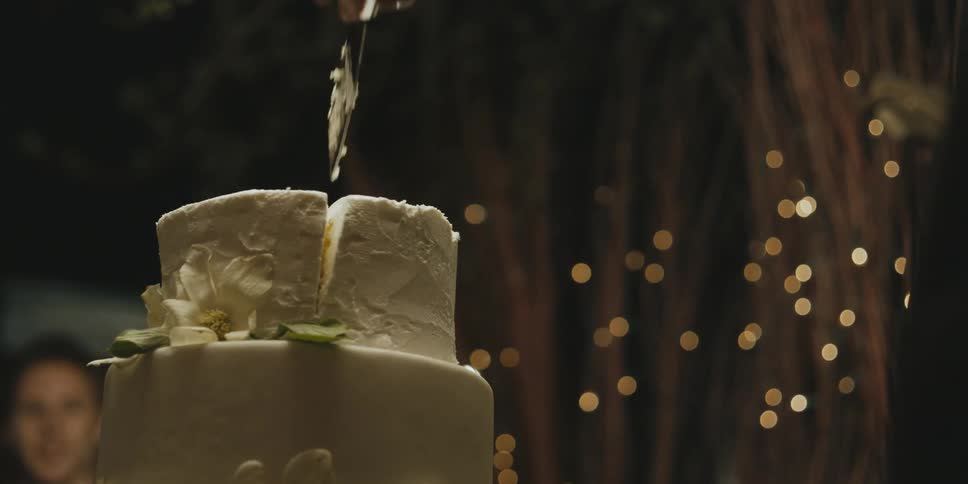 The top layer of a cake is cut