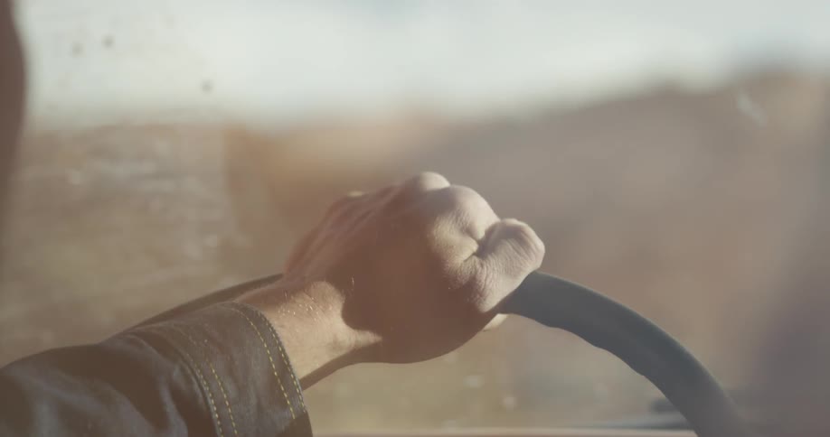 Close-up of a man driving  a vehicle from his perspective