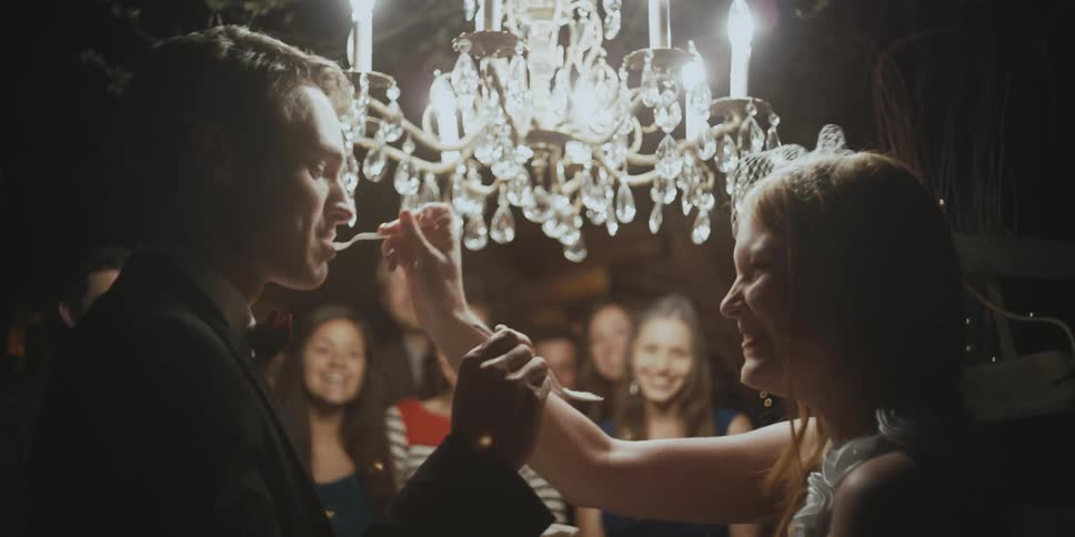 Man and woman feed each other cake on their wedding day