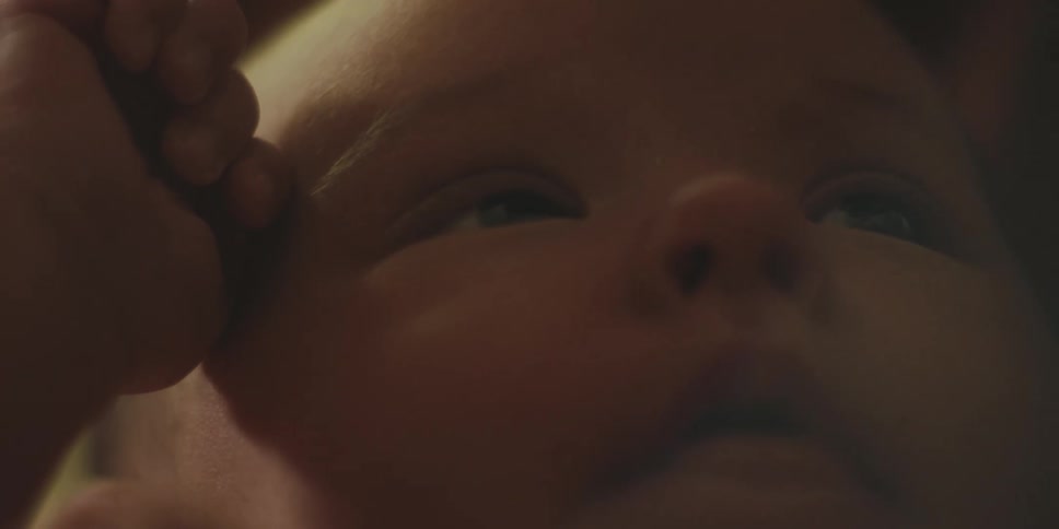 An infant clenches its fists