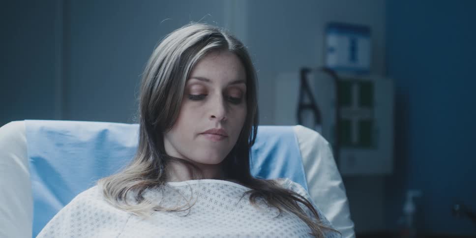 A woman is laying in a hospital bed