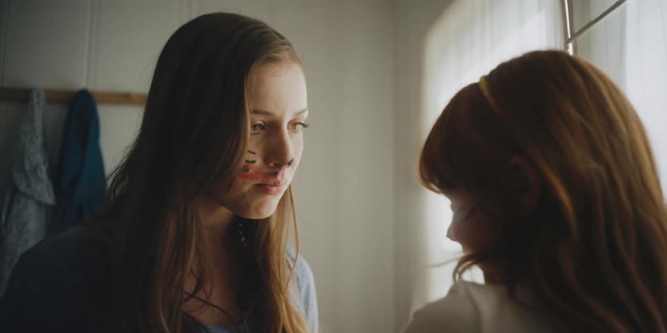 A woman is talking to her child and smiling