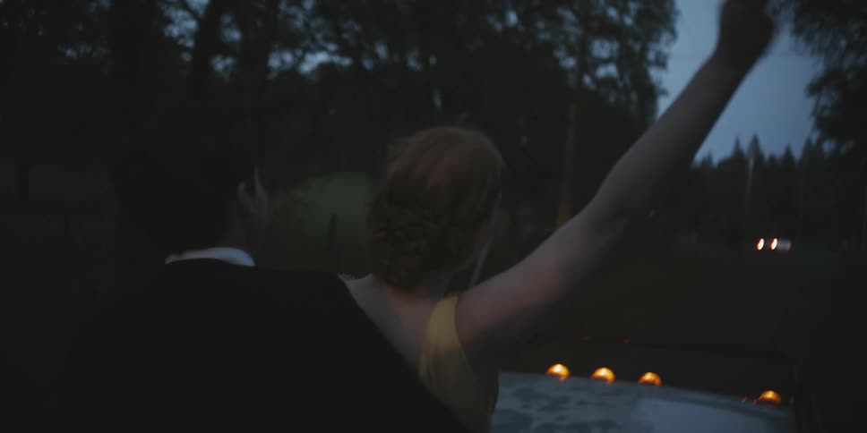 Teenagers dressed for prom ride in the back of a pickup truck