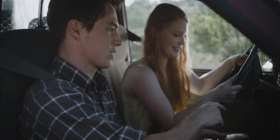 Man and woman sit in a truck talking