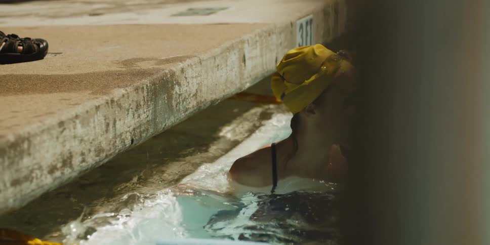 Swimmers compete in an outdoor pool