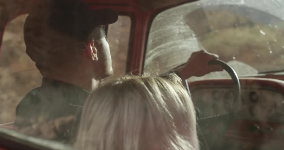 A man is driving a car with a woman next to him