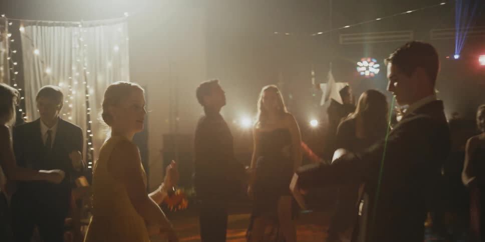 Many people dance outside at night