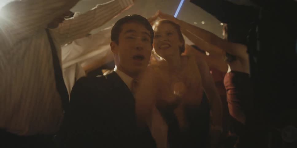 Man and woman running under arms of people