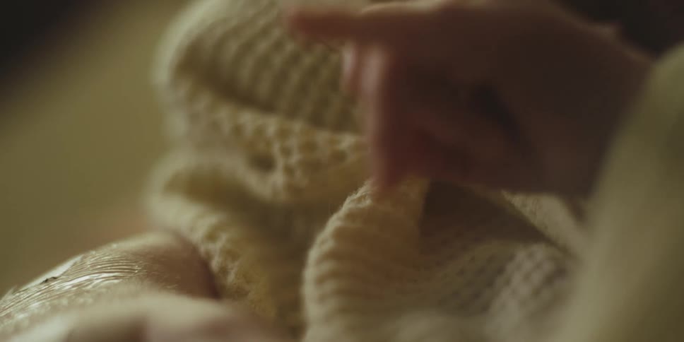 Close up of a baby's hand on a blanket