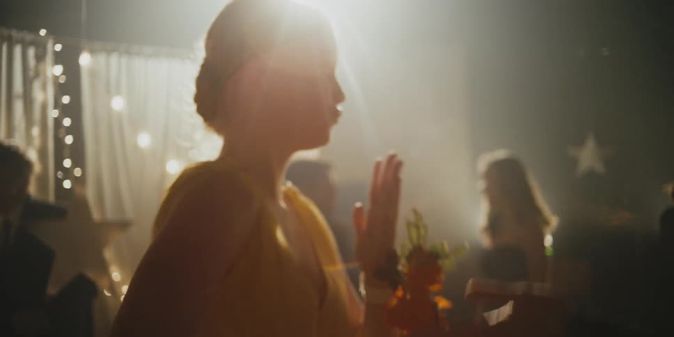 Two teenagers dance together at the prom