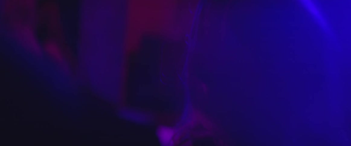 Blonde woman dancing in a crowded dark nightclub