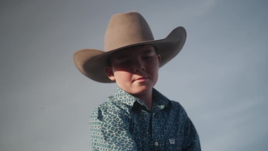 Boy sitting on and petting a horse
