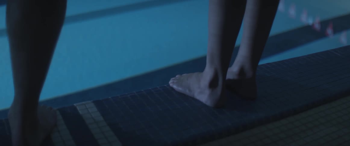 Person standing at the edge of a large pool