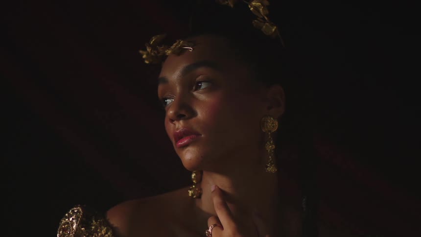 A woman is posing for the camera and wearing jewelry