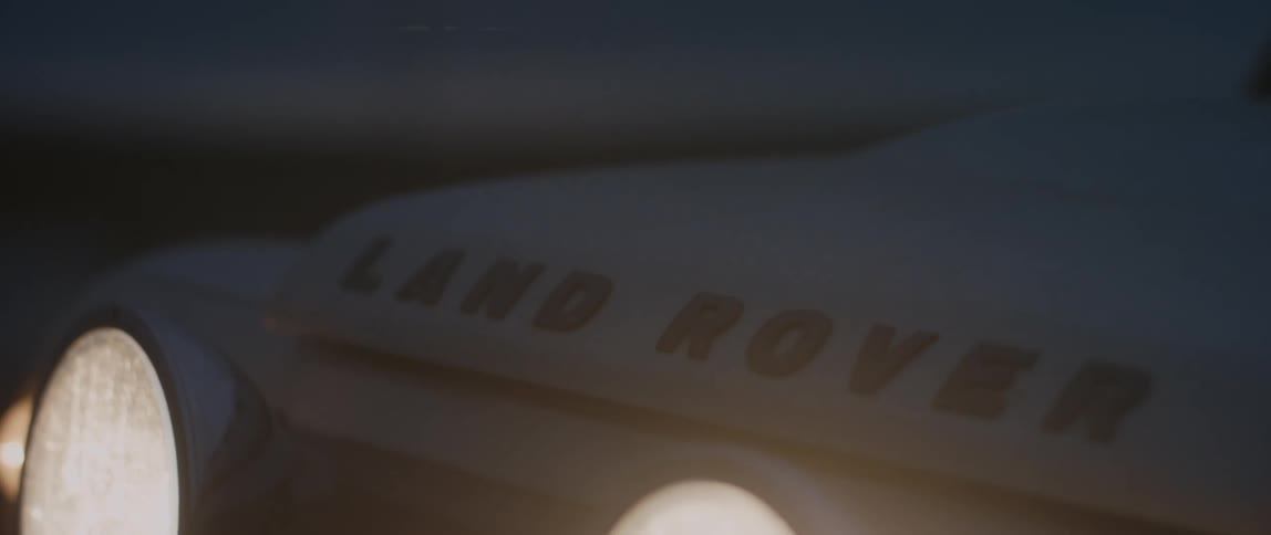 The brand logo on the hood of a vehicle at night