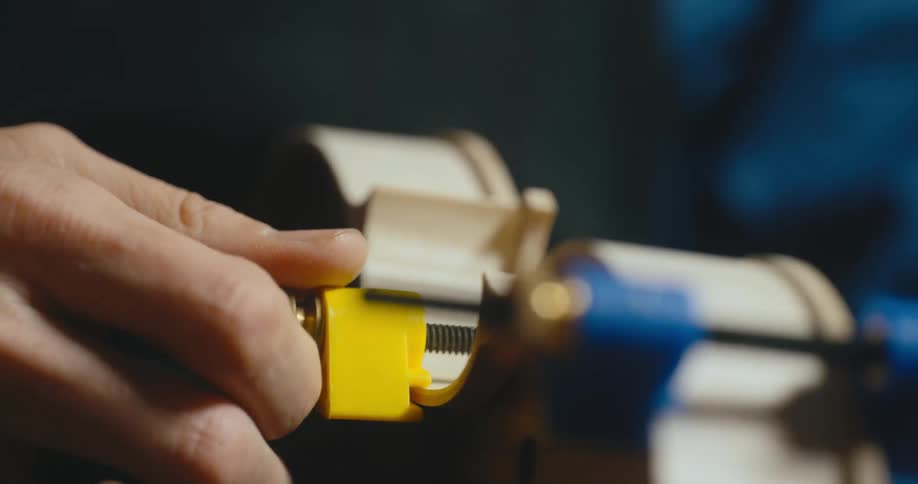 A man twists a screw on a cannister