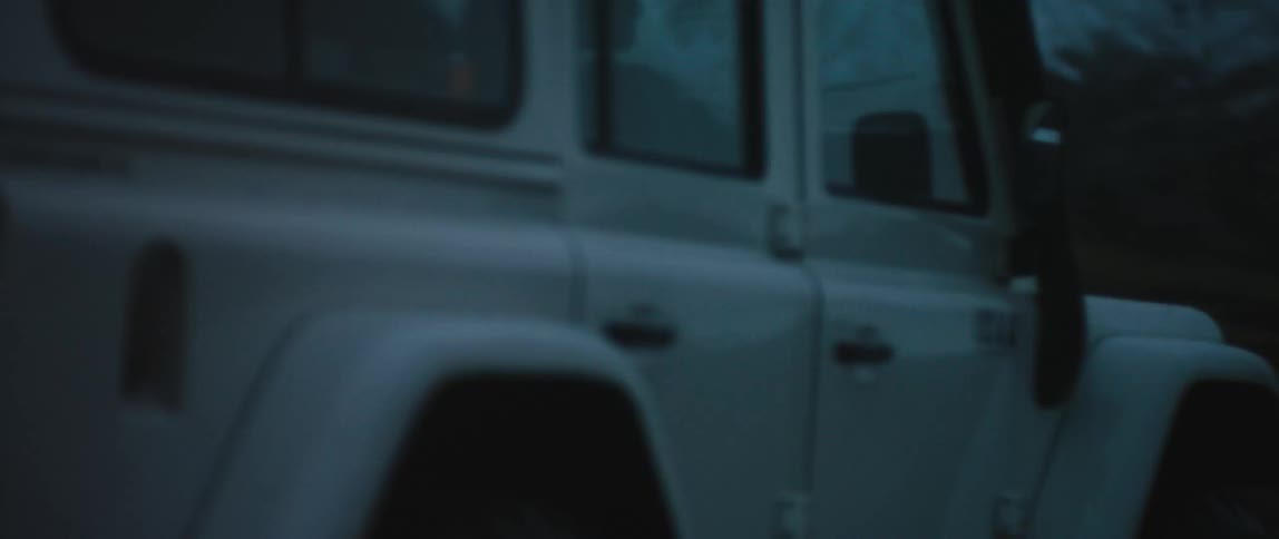 A vehicle drives towards the mountain
