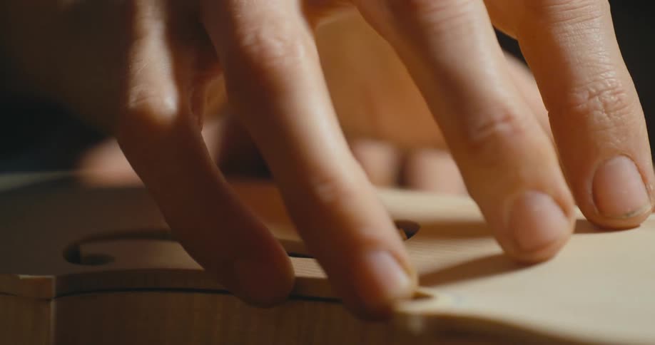 A person assembling a violin