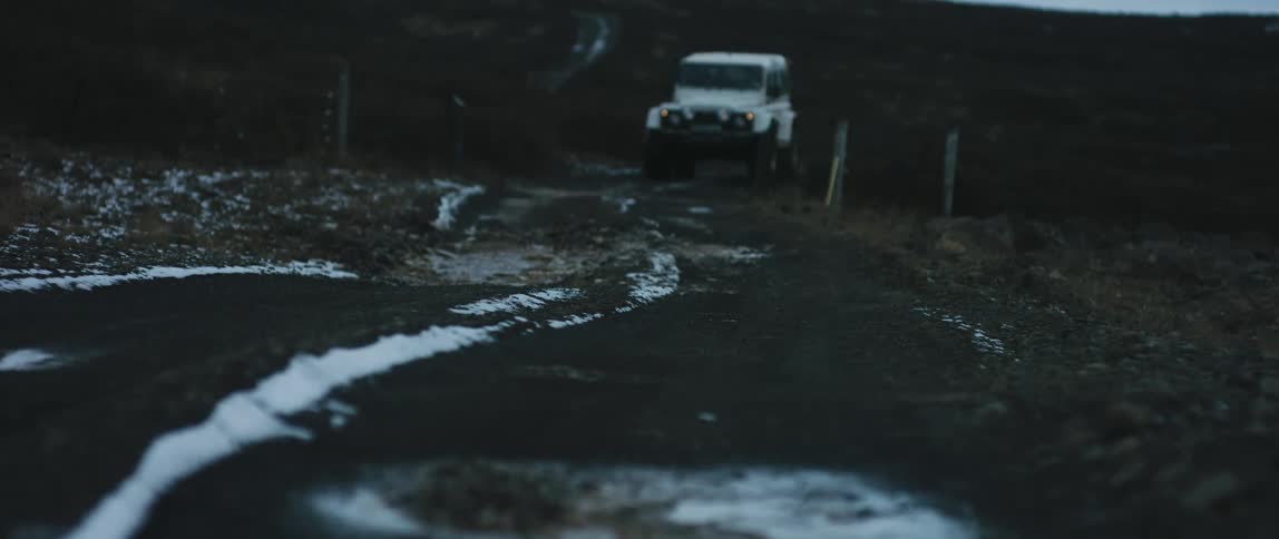 A view of a vehicle driving up a hill