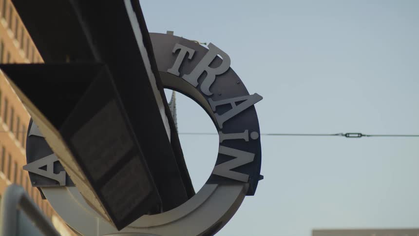 A sign is displayed on a store near the coast