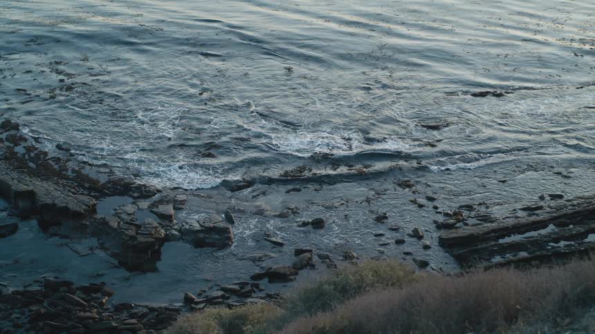 The water is crashing against the coast