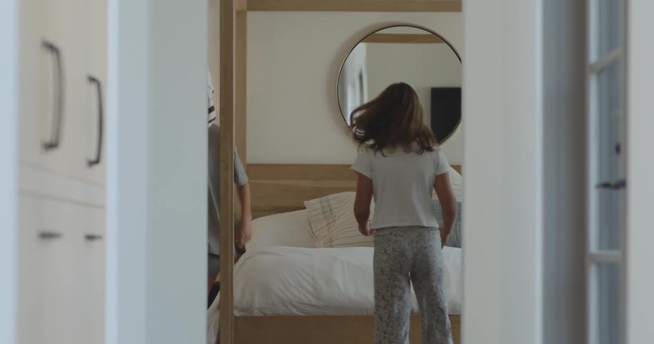 A child runs down the hall and opens a piece of paper with a woman