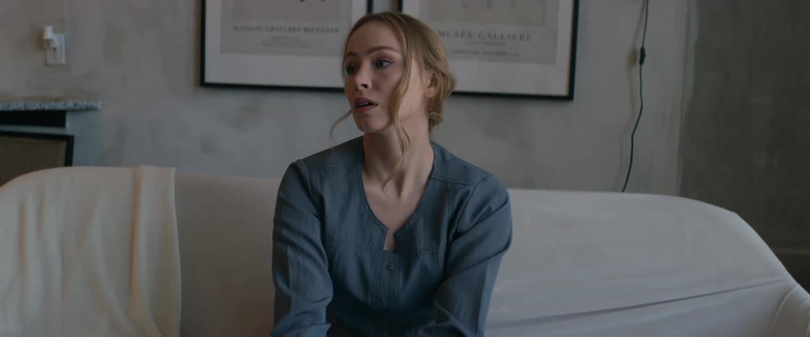 A woman is worried on the couch