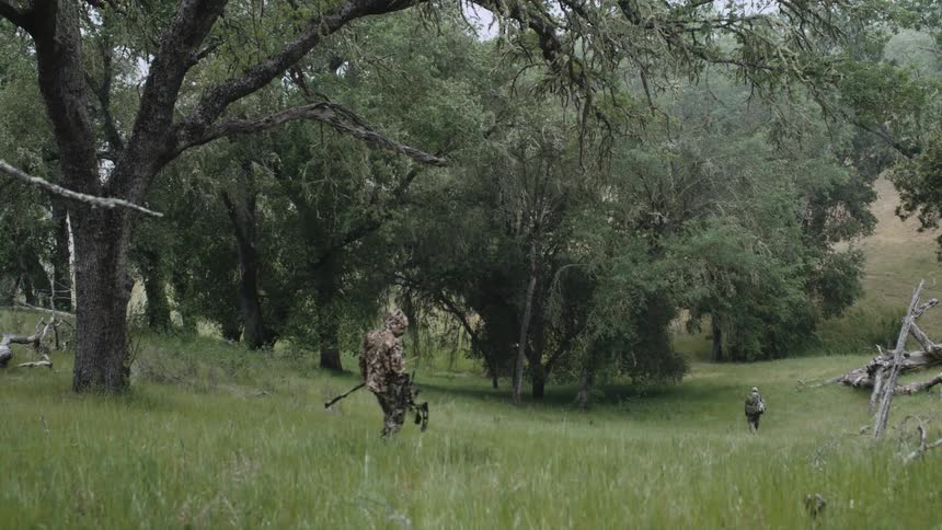 Two men are hunting through the wilderness