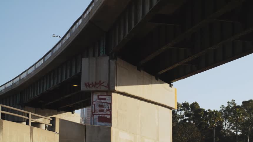 An overpass with a car driving under it