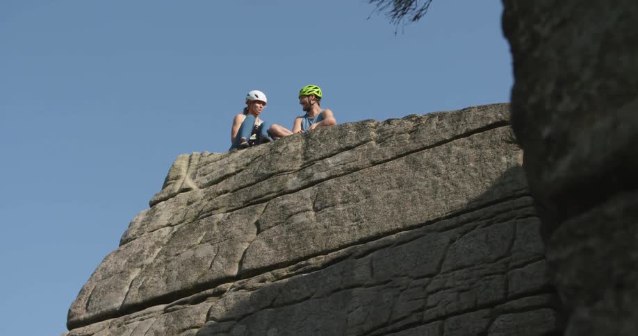 Two rock climbers talk on the cliff