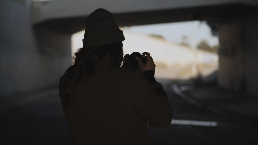 A person is photographing a tunnel outdoors in spring
